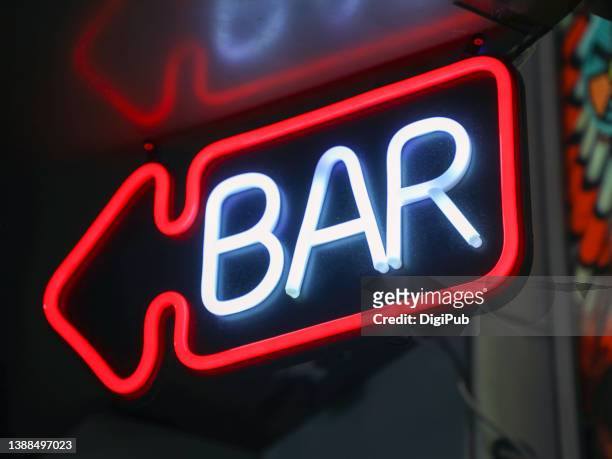 low angle view of bar sign in the night - neon sign foto e immagini stock