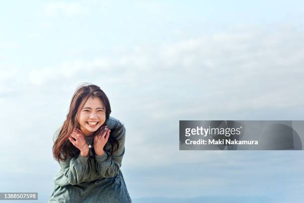 she leans forward and laughs. - beautiful japanese women stock pictures, royalty-free photos & images