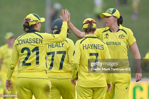 Jess Jonassen of Australia celebrates with teammate Tahlia McGrath after catching out Stafanie Taylor of the West Indies and to win the 2022 ICC...