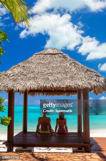 young couple in tropical house on beach - friedenssymbol bildbanksfoton och bilder