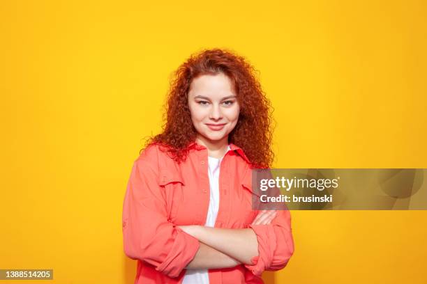 studio portrait of an attractive 20 year old red haired woman - mischief woman stock pictures, royalty-free photos & images