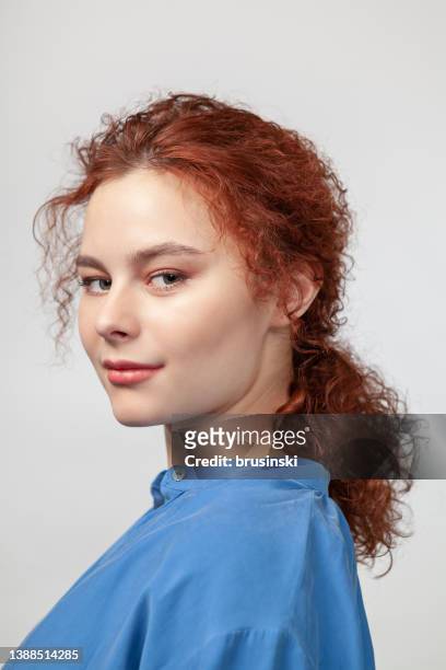 studio portrait of an attractive 20 year old red haired woman - ponytail hairstyle stock pictures, royalty-free photos & images