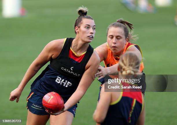 Caitlin Gould of the Adelaide Crows and Chelsea Biddell of the Adelaide Crows during an Adelaide Crows AFLW training session at Adelaide Oval on...