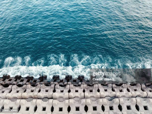 aerial view of waves beat on the reef - groyne stock-fotos und bilder