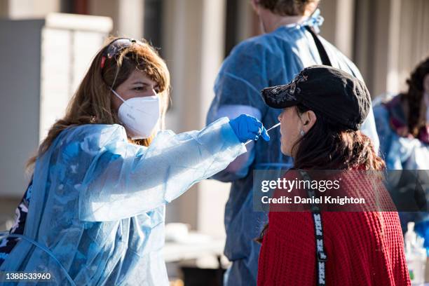 Fan is swabbed at the COVID-19 testing site prior to opening night of the Tomlin UNITED Tour on March 29, 2022 in San Diego, California.