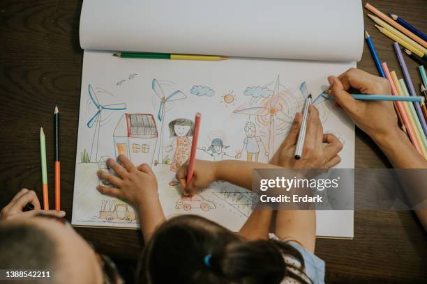 cute art product from little girl and family with eco new home and wind turbine for making alternative energy. - draw stock pictures, royalty-free photos & images