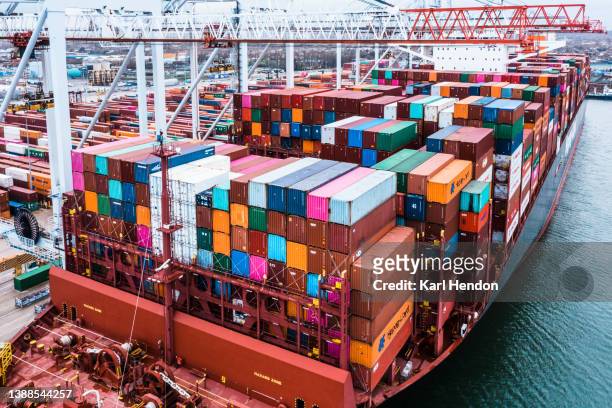an aerial view of a container ship in dock - shipyard aerial stock pictures, royalty-free photos & images