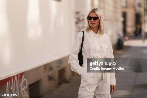 Lena Gercke seen wearing a white denim overall from LeGer, a black sunglasses from Prada and a black handbag from LeGer on March 28, 2022 in Berlin,...
