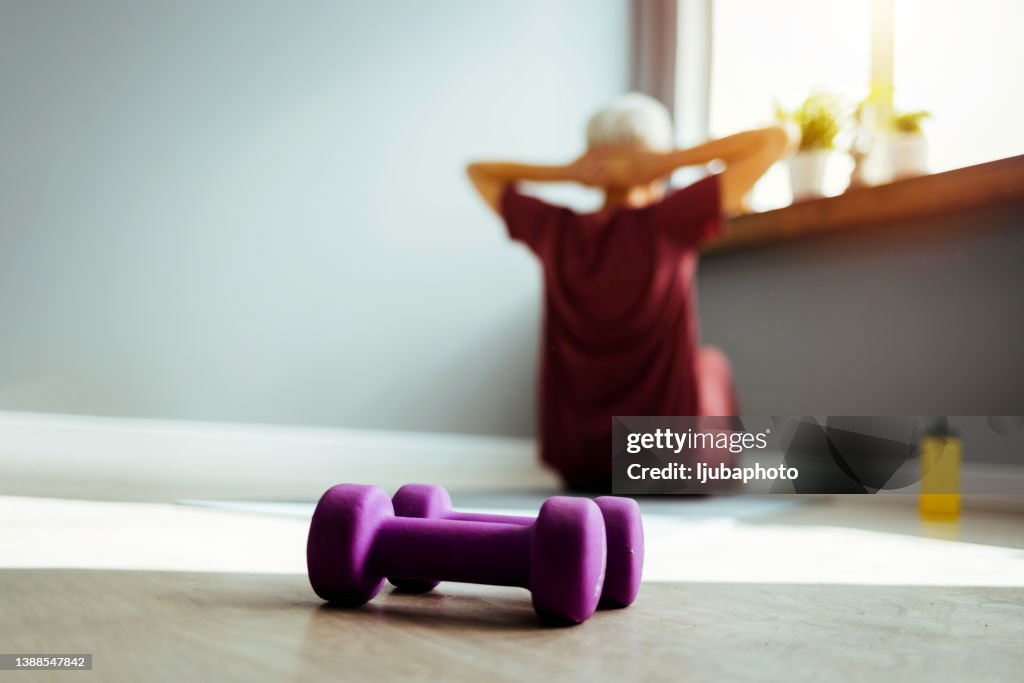 Sporty woman exercising at home.