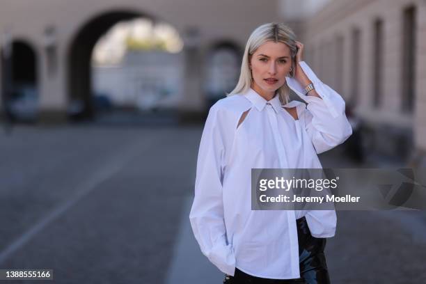 Lena Gercke seen wearing a white shirt blouse from LeGer, silver earrings from LeGer and a black latex vinyl MSGM pants on March 28, 2022 in Berlin,...