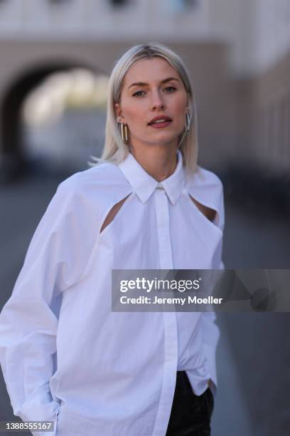 Lena Gercke seen wearing a white shirt blouse from LeGer, silver earrings from LeGer and a black latex vinyl MSGM pants on March 28, 2022 in Berlin,...