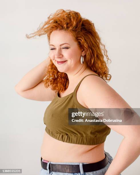 portrait of young cute smiling woman - fat redhead stock pictures, royalty-free photos & images