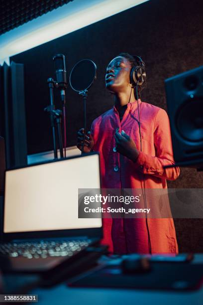 black woman singing and recording in the music studio - professional musician stock pictures, royalty-free photos & images