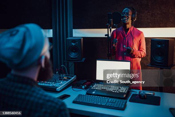 black woman singing and recording in the music studio - scoring music stock pictures, royalty-free photos & images