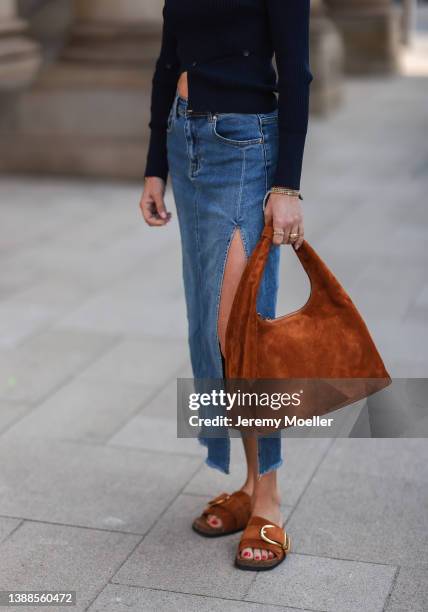Sue Giers is seen wearing Jacquemus navy blue cut out crop top, Stella Sabatoni blue denim skirt, Khaite brown leather sandals and matchy brown...