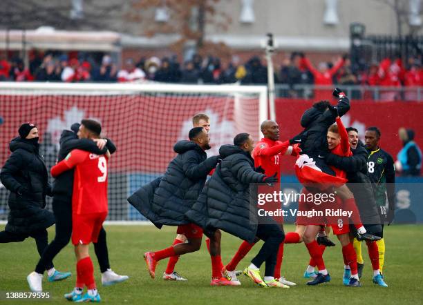 Cyle Larin, Atiba Hutchinson, Jonathan Osorio, Liam Fraser, Stephen Eustáquio of Canada celebrate victory with teammates following a 2022 World Cup...