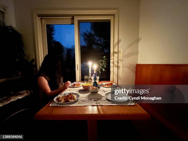 teenage girl enjoying a candlelit dinner that she prepared at home - candle light dinner stock pictures, royalty-free photos & images