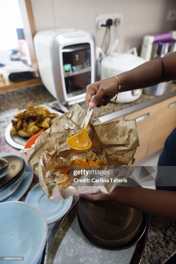 Hands serving take out roti prata