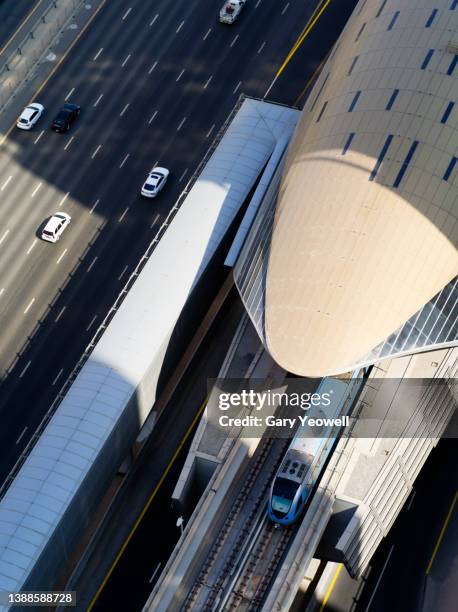 elevated view over sheikh zayed road and railway in daytime - aerial train stock-fotos und bilder