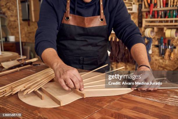 faceless woodworker making guitar in workshop - tool rack stock pictures, royalty-free photos & images