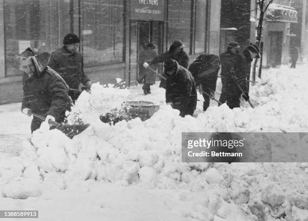 New Yorkers brave the high winds and piles of snow outside the news building on 42nd Street in New York City, New York, 4th February 1961. New York...