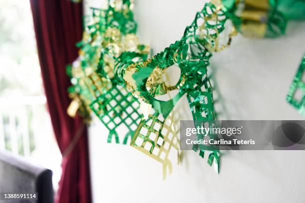 ketupat garland hanging on a wall for hari raya - raya decoration stock pictures, royalty-free photos & images