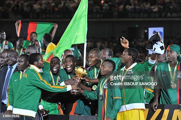 Zambia's national football team players celebrate with cup after their victory against Ivory Coast at the Stade de l'Amitie in Libreville on February...