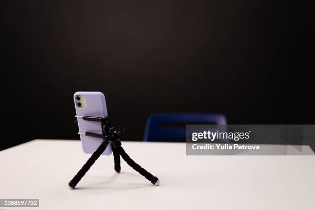 the phone is on a tripod on the table, preparation for live broadcast, communication, work call - tripod stock pictures, royalty-free photos & images