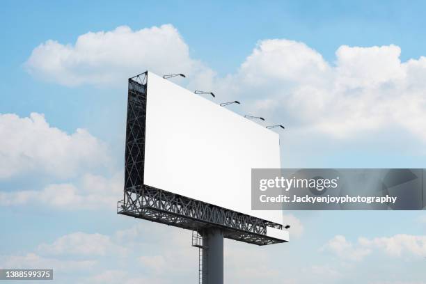 blank billboard at blue sky background - draft media opportunity stock-fotos und bilder