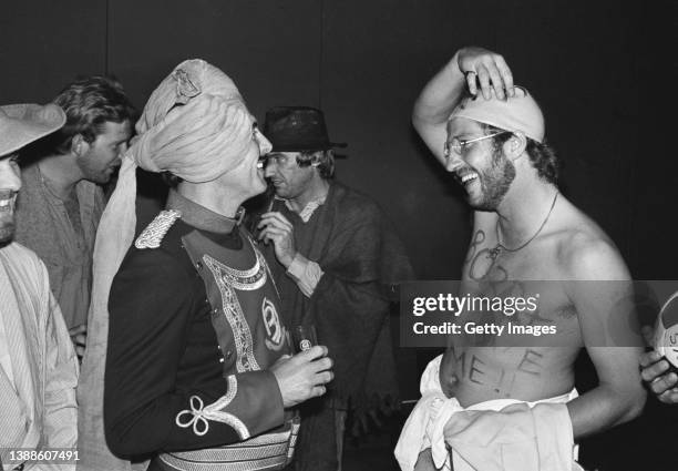 England players Geoff Boycott and Ian Botham share a joke at the England Christmas fancy dress party in Delhi where Botham had come dressed as...