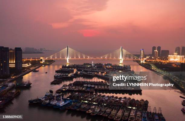 ship and boat parked inside the modern haikou century bridge to avoid typhoon - haikou stock pictures, royalty-free photos & images