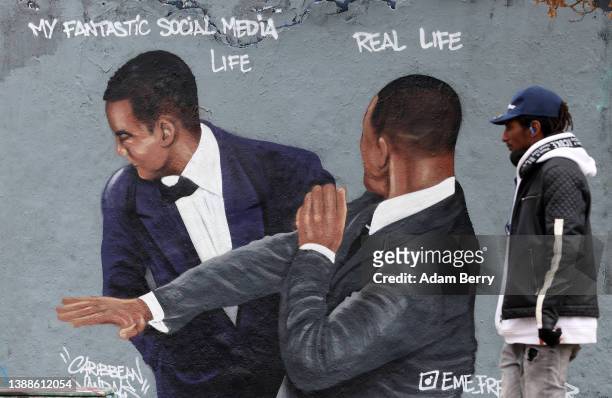 Graffiti depicting a meme showing actor Will Smith slapping comedian Chris Rock, criticizes idealized self-portrayals of social media users' lives,...
