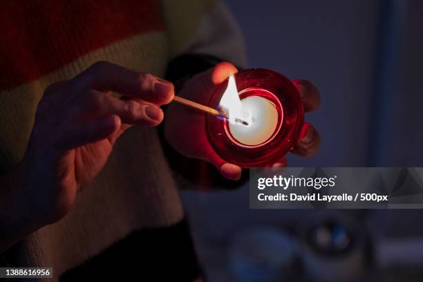 candle,midsection of woman holding illuminated candle,lingfield,united kingdom,uk - david wicks stock pictures, royalty-free photos & images