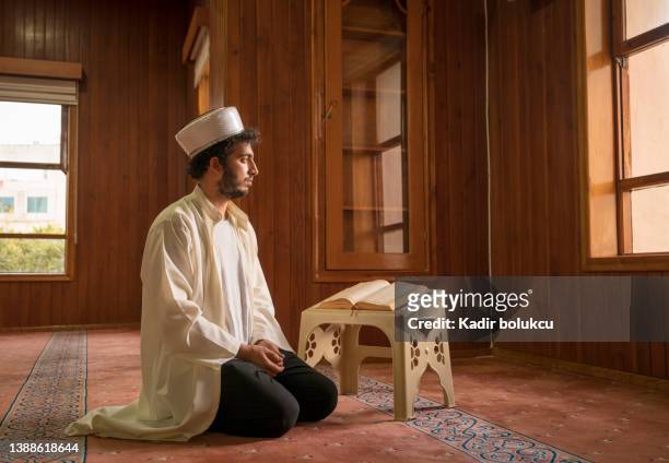 muslim cleric praying in mosque. - imam stock pictures, royalty-free photos & images