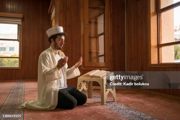 muslims praying in mosque. - shah mosque stock pictures, royalty-free photos & images