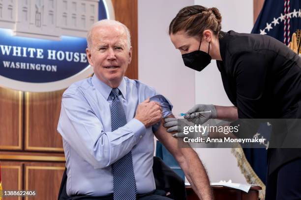 President Joe Biden receives a fourth dose of the Pfizer/BioNTech Covid-19 vaccine in the South Court Auditorium on March 30, 2022 in Washington, DC....