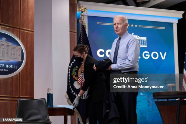 President Joe Biden listens to a reporter's question before receiving his fourth dose of the Pfizer/BioNTech Covid-19 vaccine in the South Court...