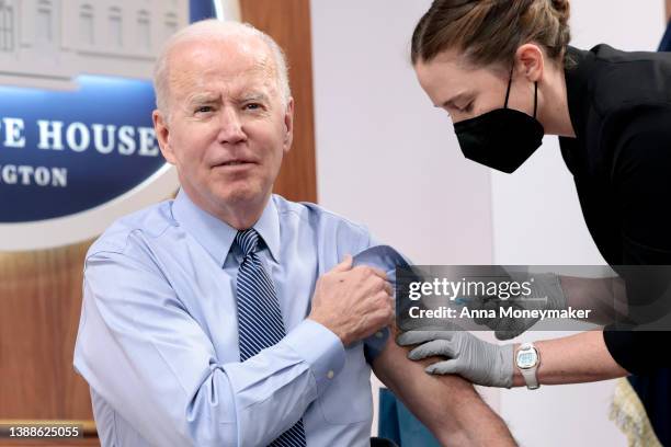 President Joe Biden receives a fourth dose of the Pfizer/BioNTech Covid-19 vaccine in the South Court Auditorium on March 30, 2022 in Washington, DC....