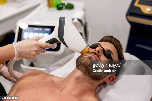 man getting a laser hair removal on his face - laser surgery stock pictures, royalty-free photos & images