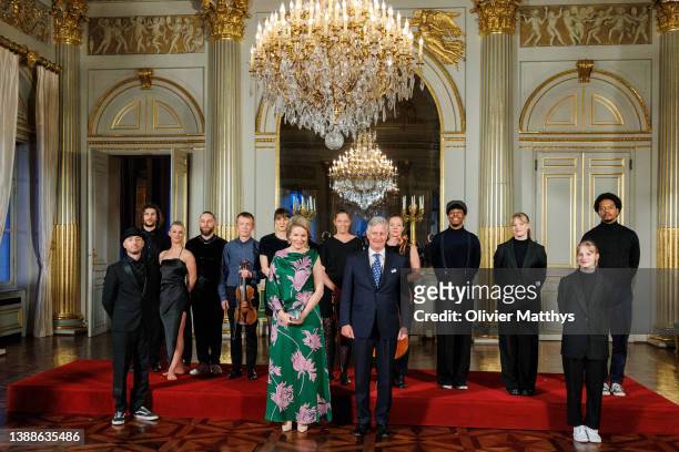 King Philippe of Belgium and Queen Mathilde and take a picture with the artists of the annual spring concert at the Royal Palace on March 30, 2022 in...