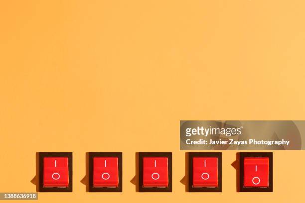 five rocker switches on orange background - turning on or off stock pictures, royalty-free photos & images