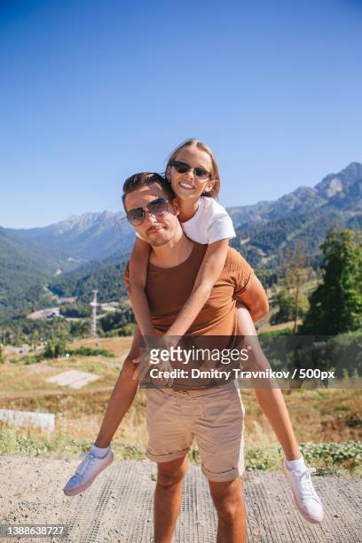 beautiful happy family in mountains in the background - sotschi stock pictures, royalty-free photos & images