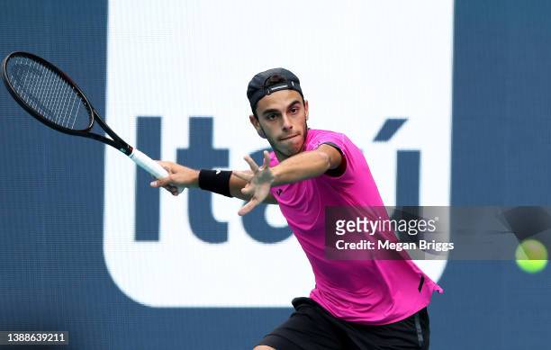 Francisco Cerundolo of Argentina returns a shot to Jannik Sinner of Italy during the Men's Singles match on Day 10 of the 2022 Miami Open presented...