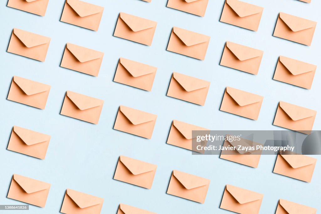 Many Beige Envelopes On Blue Colored Background