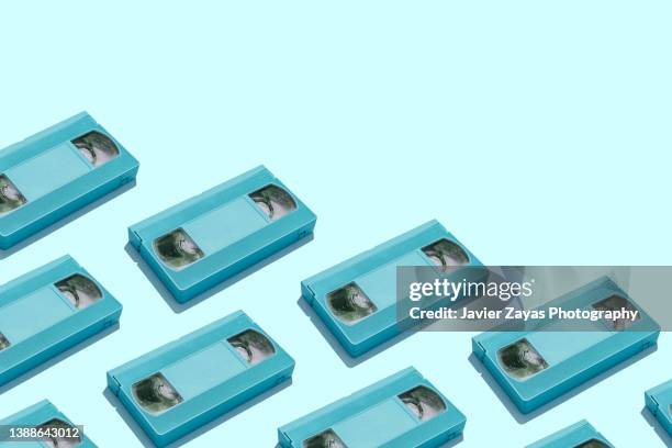 still life of some blue vhs cassette on blue background - retro television stock pictures, royalty-free photos & images