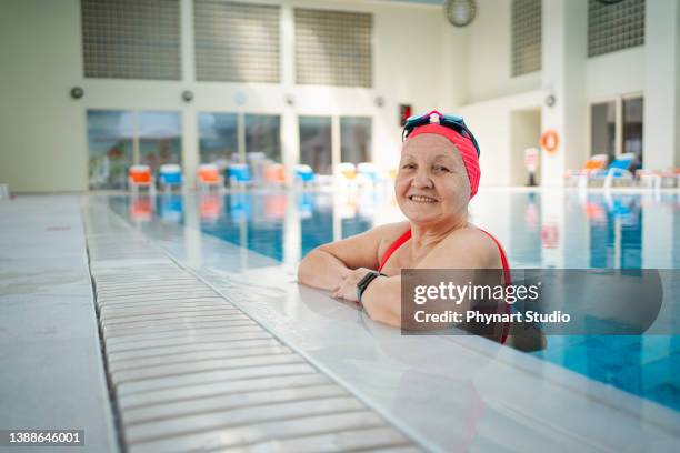 happy senior woman in swimming pool - old lady swimming stock pictures, royalty-free photos & images