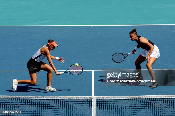 Magda Linette of Poland returns a shot Laura Siegemund and Vera Zvonareva of Germany while playing with Sara Sorribes Tormo of Spain during the Miami...