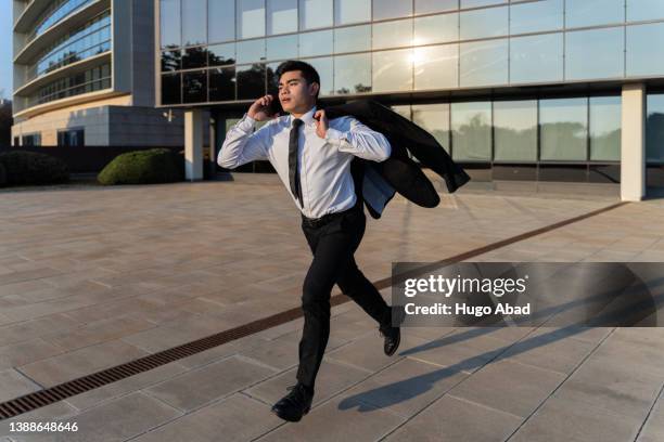 asian businessman running in a hurry. - unhappy salesman stock pictures, royalty-free photos & images