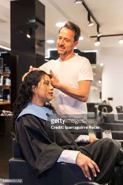 modern and luxury hairdressing salon, a hairdresser and a female client with wet curly hair during styling before the haircut - guipuzcoa province stock pictures, royalty-free photos & images