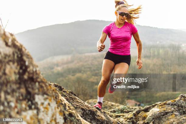 strong woman running on mountain - cross country running stock pictures, royalty-free photos & images